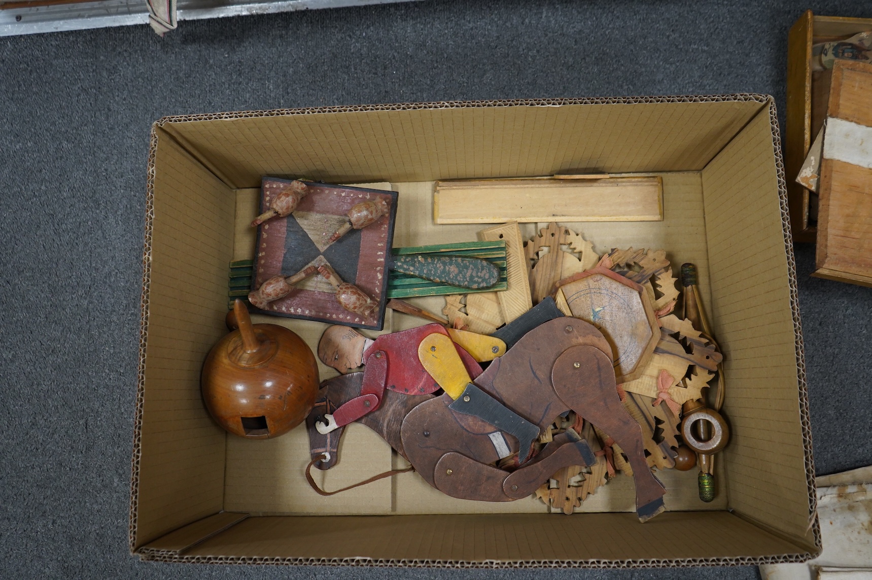 A collection of 19th century toys including; an early Jaques Ping Pong or Gossima set in an illustrated wooden case, a Crandall’s John Gilpin wooden horse with folded linen backed poster, ‘The Adventures of John Gilpin’